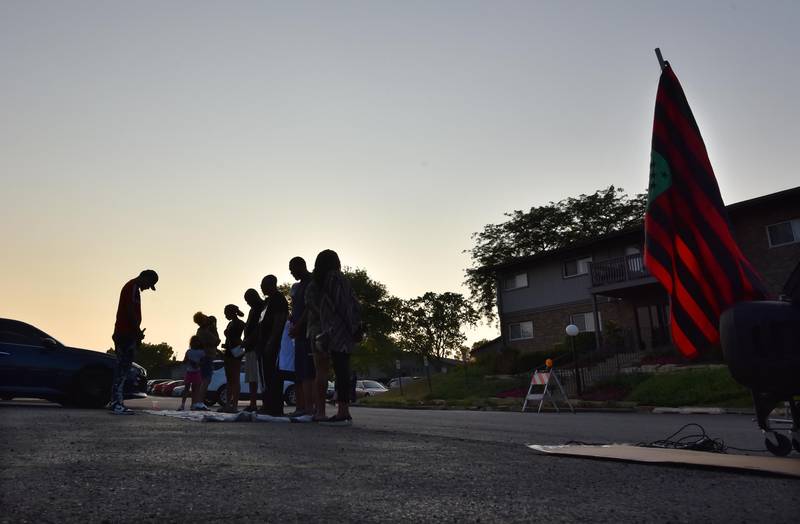Rabbi Michael Ben Yosef, human rights and anti-violence activist of Chicago, prays with a small group near the scene of a mass shooting in Willowbrook on Monday, June 20, 2023. The shooting killed one man and injured more than 20 others Sunday morning at a Juneteenth party.