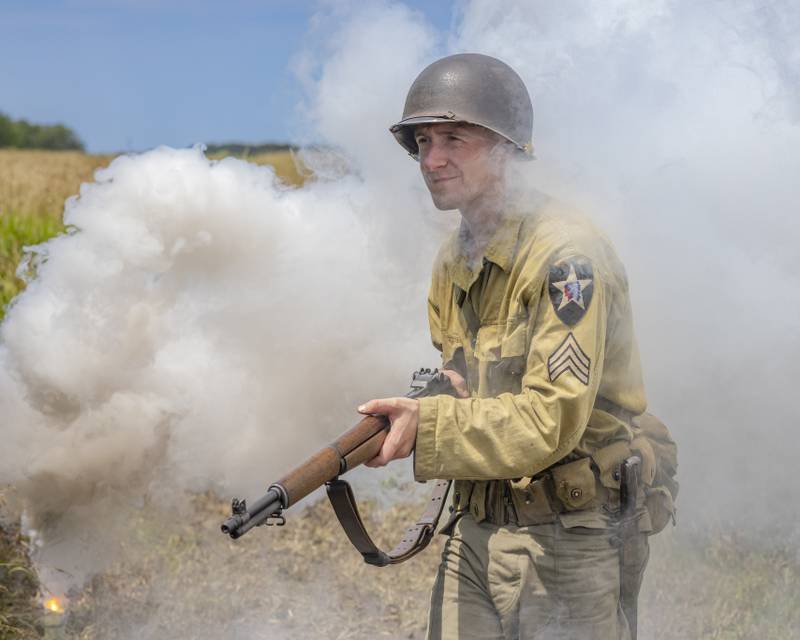 American reenactor Travis Hanlin pushes up the battlefield through the smoke Sunday, July 14, 2024, during the Ottawa Military Show in rural Ottawa.
