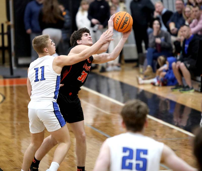 Wheaton Warrenville South's Luca Carbonaro struggles to hold onto the ball against Geneva’s Nelson Wendell during a Class 4A St. Charles East Sectional semifinal on Wednesday, March 5, 2025 in St. Charles.