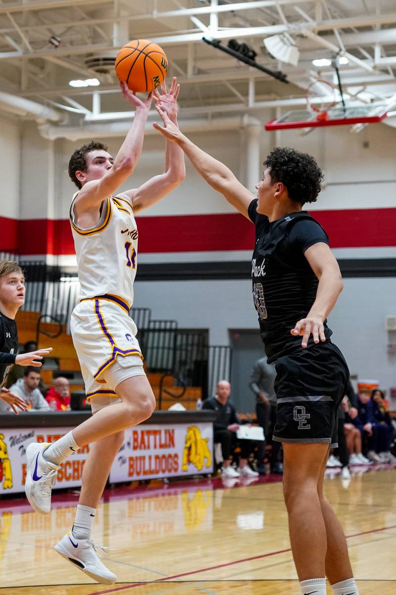 Downers Grove North's Jack Crowley (11) shoots the ball over Oswego East's Damien Lewandowski (10) during a Batavia Night of Hoops Basketball game at Batavia High School on Saturday, Jan. 25, 2025.