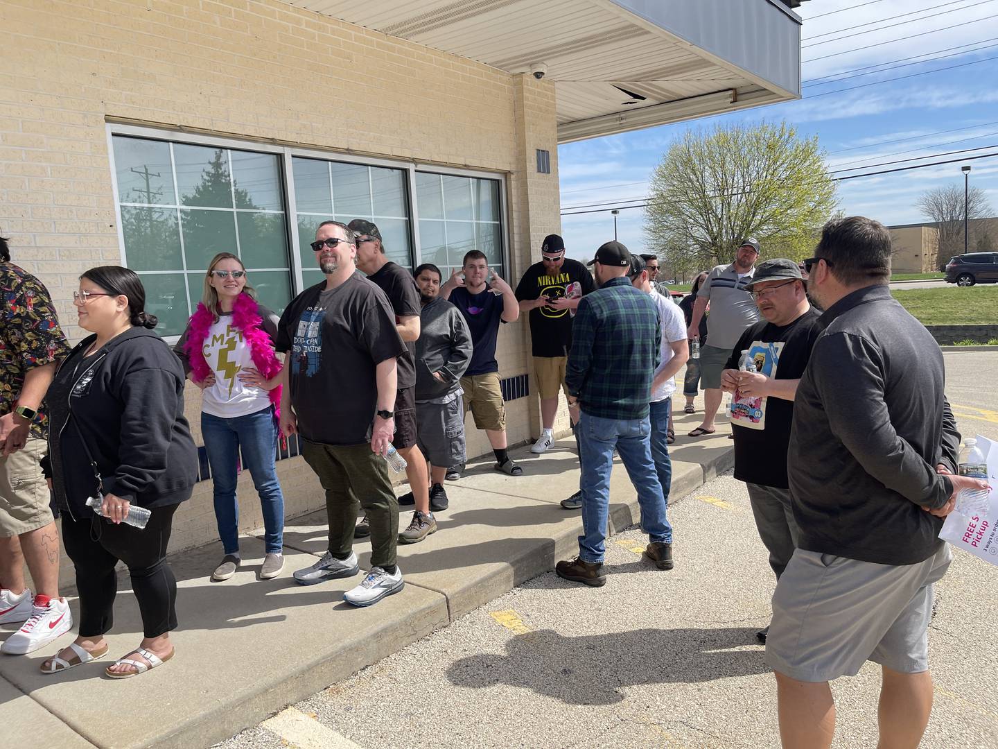 People stand in line on Saturday, April 15, 2023 outside of Ivy Hall Dispensary in Crystal Lake to meet wrestling icon Ric Flair. Flair was in attendance to both meet fans and promote a new line of marijuana products, "Ric Flair Drip."