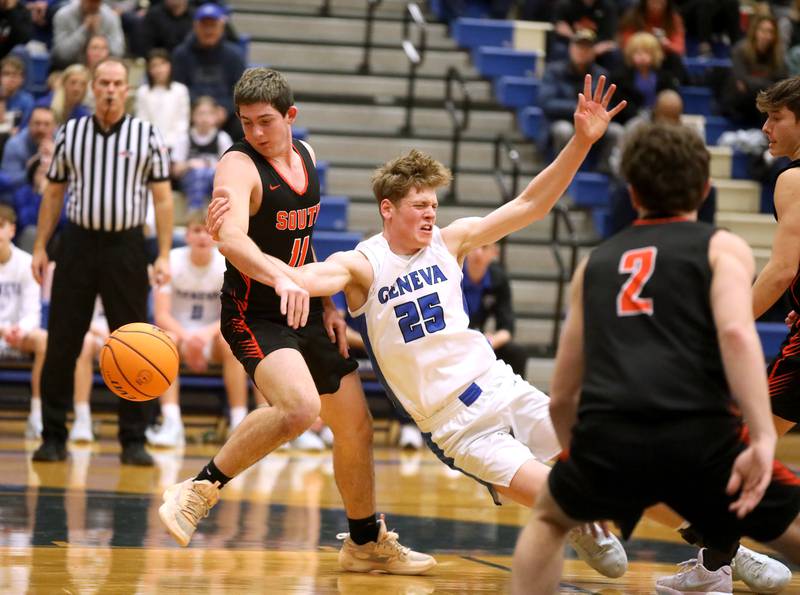 Geneva’s Hudson Kirby loses his footing as Wheaton Warrenville South’s Zach Rogers goes after the ball during a game on Friday, Jan. 24, 2025 at Geneva.