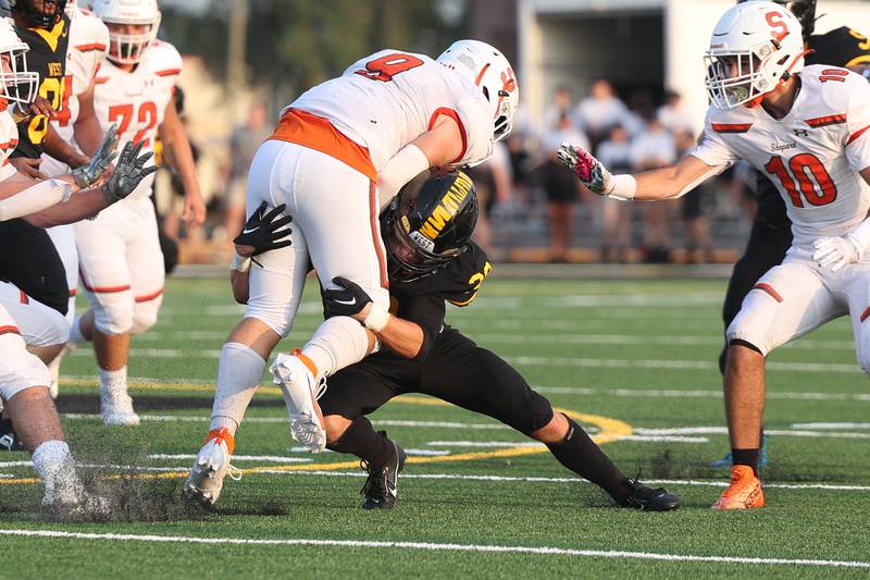 Joliet West’s Austin Kitti tackles Shepard’s Jimmy Las Cola for a loss on Friday, Aug. 25, 2023 in Joliet.