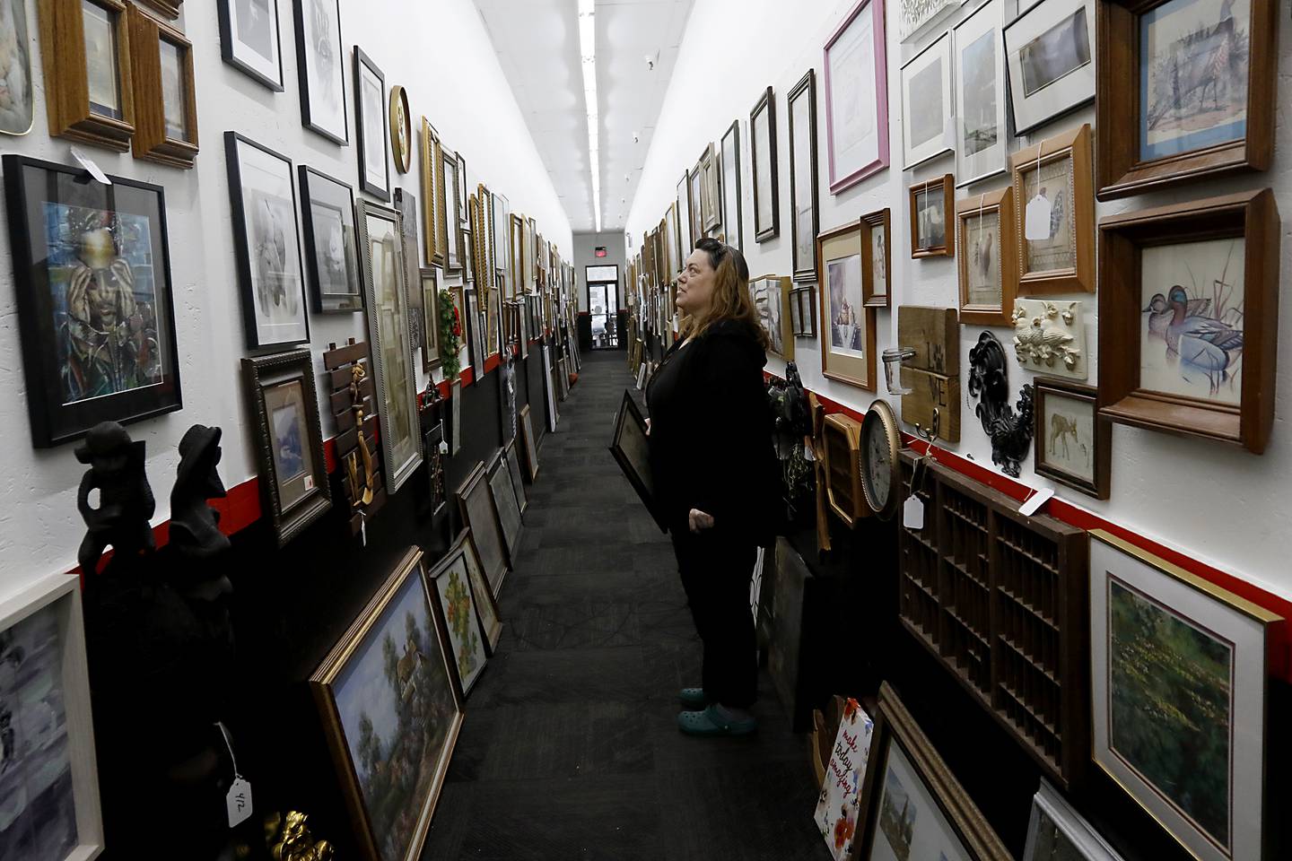 Mandi Graf, of the D&M Finds booth in Q'Tiques in McHenry works on preparing Q'Tiques and her booth on Tuesday, March 4, 2025, for this weekend's Shop Hop. More than 300 vintage and antique shops are participating in Shop Hop Weekend in Wisconsin and Illinois.