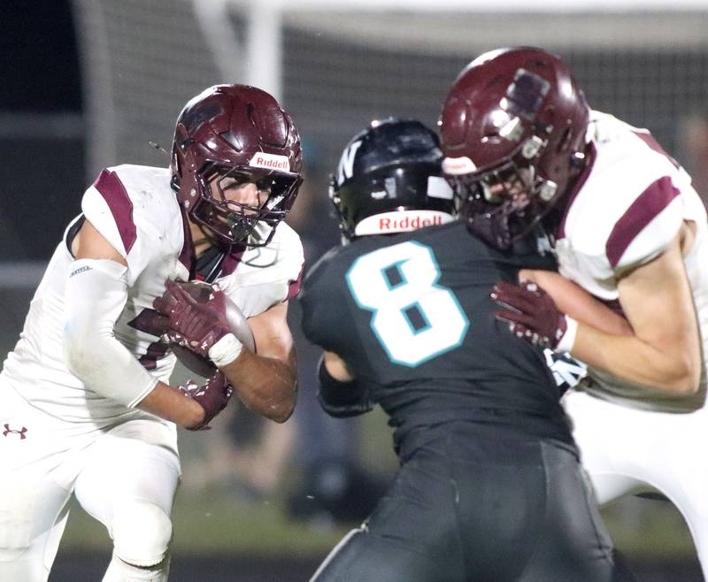 Marengo’s Gavin Baros looks for running room against Woodstock North in varsity football at Rod Poppe Field on the campus of Marengo High School in Marengo on Friday, Sept. 12, 2025.