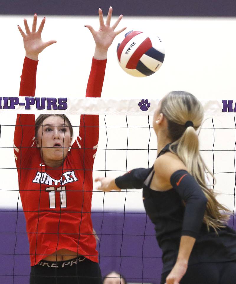Huntley's Riley Galanis block the hit of lb18\ during an IHSA Class 4A Hampshire Sectional semifinal volleyball match on Tuesday, Nov. 4, 2025, at Hampshire High School.