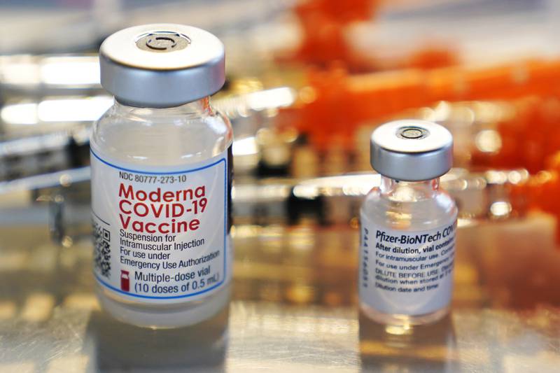 FILE - Vials for the Moderna and Pfizer COVID-19 vaccines are seen at a temporary clinic in Exeter, N.H. on Thursday, Feb. 25, 2021. The Food and Drug Administration has authorized another booster dose of the Pfizer or Moderna COVID-19 vaccine for people age 50 and up, Tuesday, March 29, 2022.   (AP Photo/Charles Krupa, File)