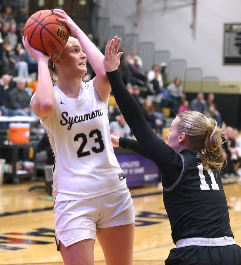 Sycamore's Evyn Carrier shoots the ball over Kaneland's Berlyn Ruh during the Class 3A regional final game Friday, Feb. 17, 2023, at Sycamore High School.