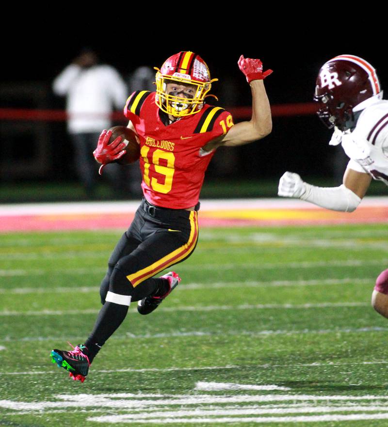 Batavia’s Zach Granberg carries the ball during a Class 7A round 1 playoff game against Brother Rice in Batavia on Friday, Oct. 27, 2023.