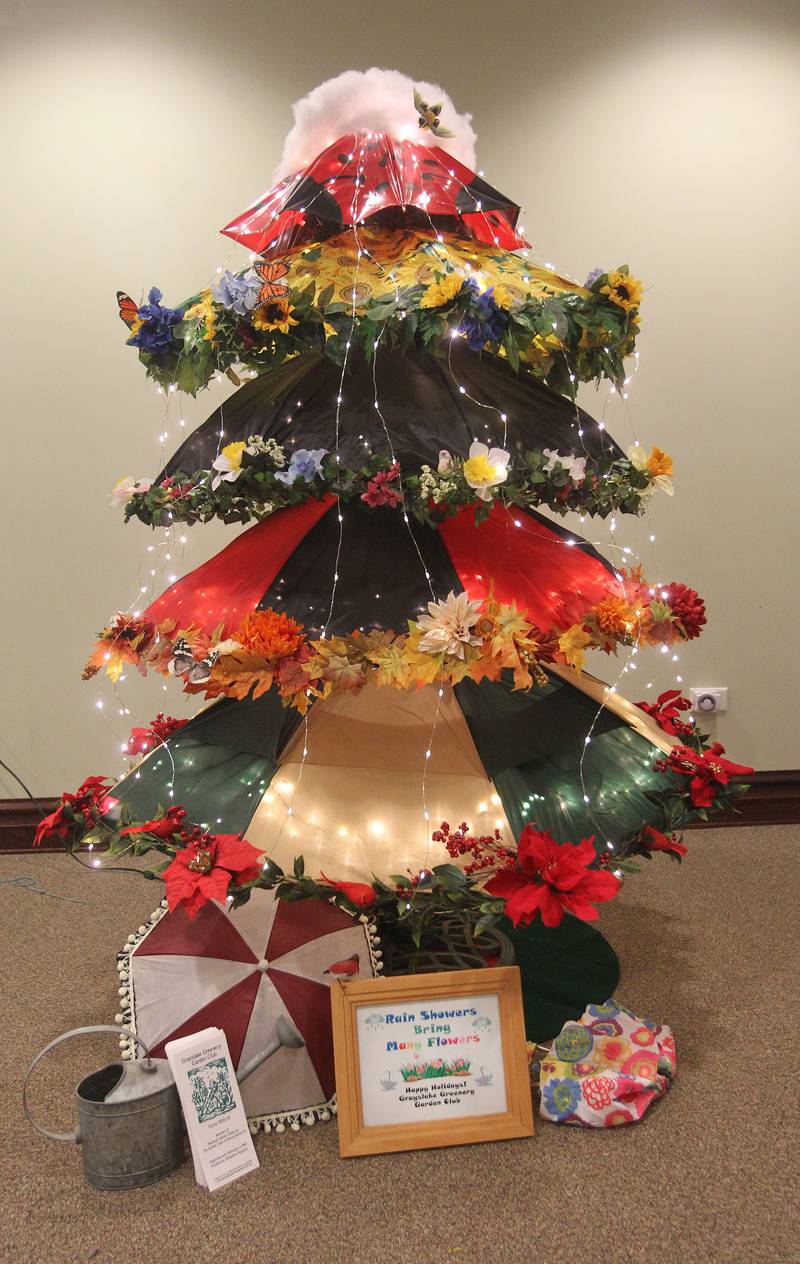 Umbrellas, lights, flowers and greenery were used to make the Grayslake Greenery Garden Club tree, with the theme, "Rain Showers Bring Many Flowers," on display in the Giving Trees exhibit at the Grayslake Heritage Center & Museum