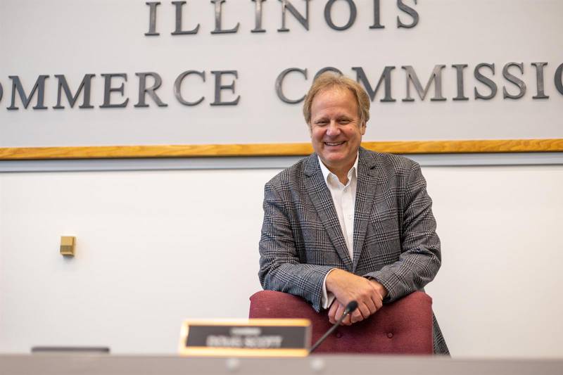 Doug Scott stands for a photograph in the hearing room at the Illinois Commerce Commission offices in downtown Chicago.
