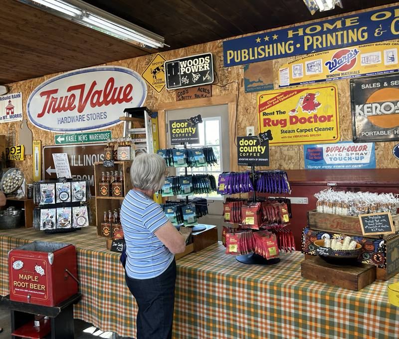 A woman looks over items at Hough's Maple Lane Farm during the Back Roads Market event on Saturday, Sept. 28, 2024 north of Mt. Morris. The event included several stops near Mt. Morris.