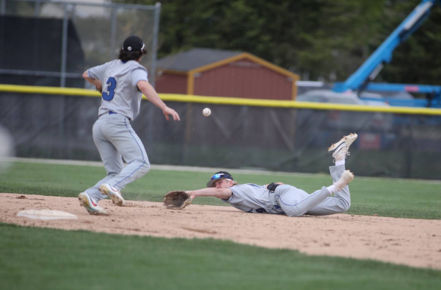 Geneva’s Sam Seykora (right) tosses the ball to teammate Nate Stempowski during a game at Batavia on Monday, April 29, 2024.