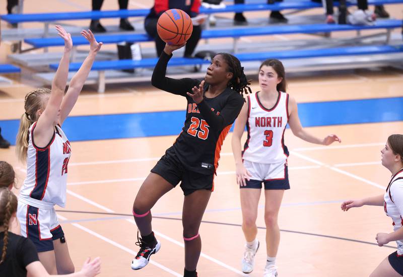 DeKalb’s Kezaria Mitchell shoots between three Belvidere North defenders during their game Friday, Nov. 17, 2023, in the Mark Einwich Varsity Girls Basketball Rockets Kickoff Tournament at Burlington Central High School.