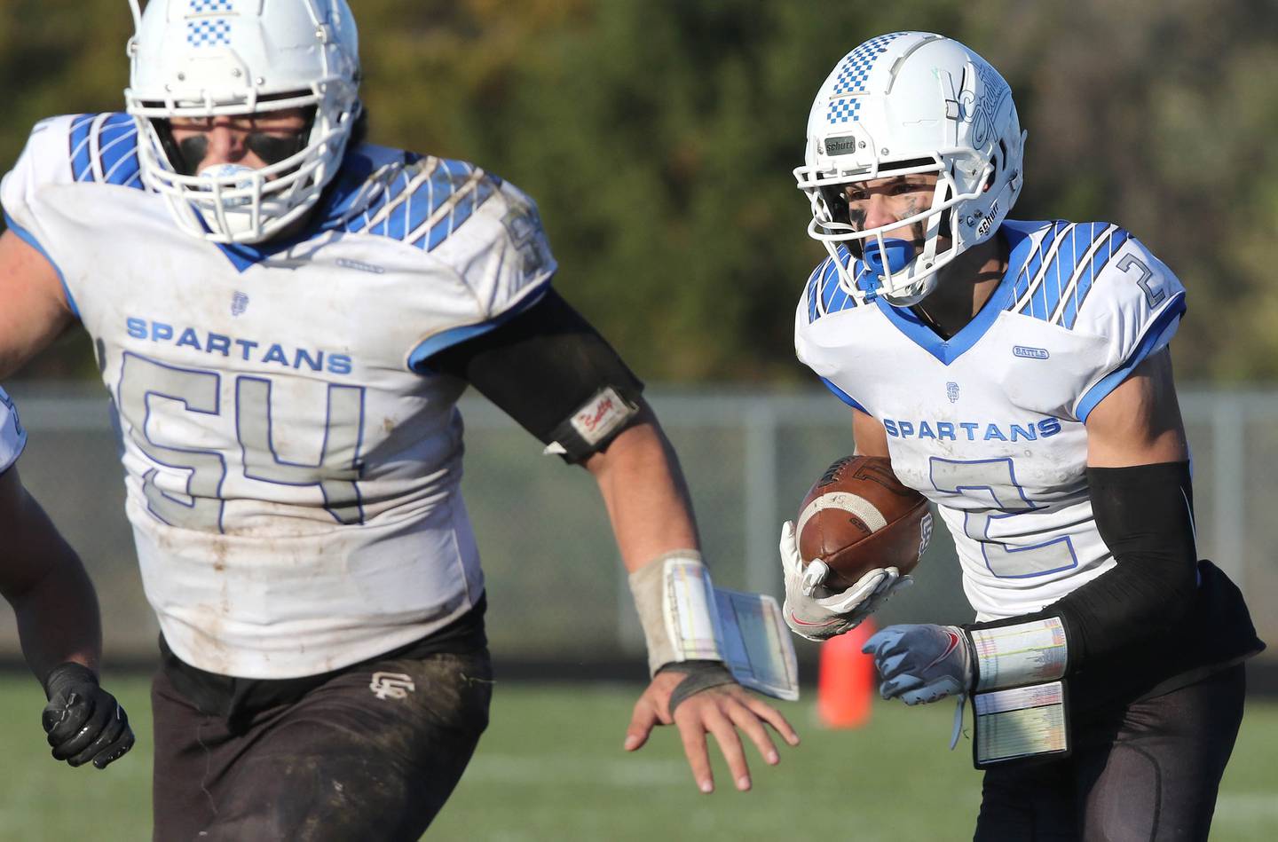 St. Francis' Adam Criter follows the blocking of TJ Mcmillen Saturday, Nov. 6, 2021, during their IHSA Class 4A playoff game at Genoa-Kingston High School.