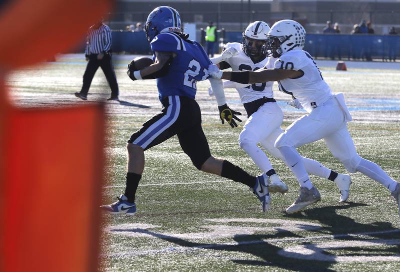 Cary-Grove's Connor Anderson (center) and Thomas Battaglia (right) tackle Lake Zurich's Chris Pirrone during a IHSA Class 6A semifinal playoff football game on Saturday, Nov. 18, 2023, at Lake Zurich High School.