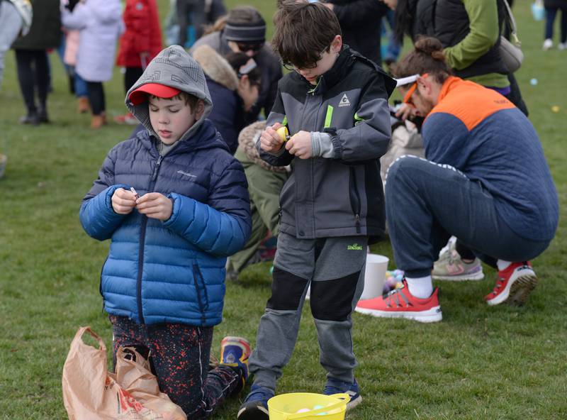 Ford Carmody of LaGrnage and Colin Novosad of Lagrange open their Easter Eggs during the LaGrange Park District Easter Egg Hunt Saturday, March 23, 2024.