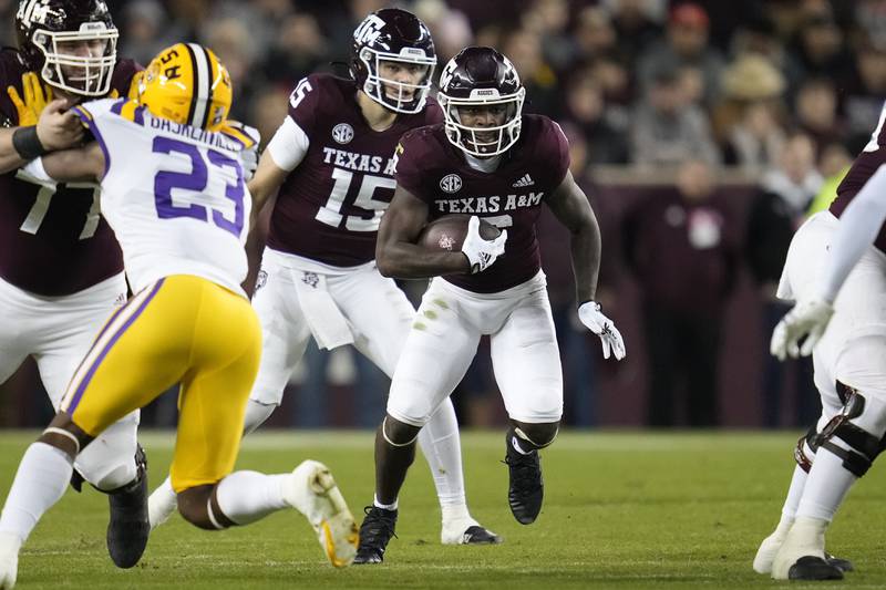 Texas A&M running back Devon Achane runs through an open hole against LSU during the first quarter of an NCAA college football game Saturday, Nov. 26, 2022, in College Station, Texas.