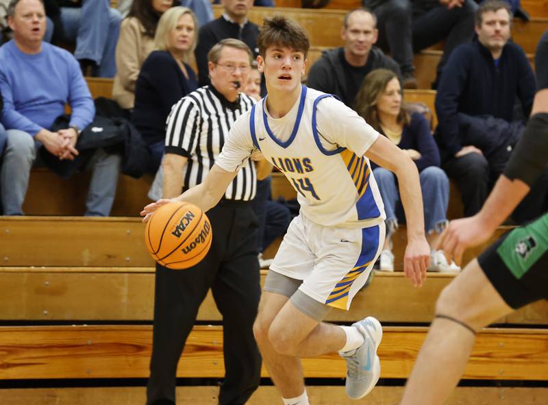 Lyons' Grant Smith (14) handles the ball during a varsity basketball game between York Community and Lyons Township high schools on Friday, Jan. 9, 2026 in La Grange.