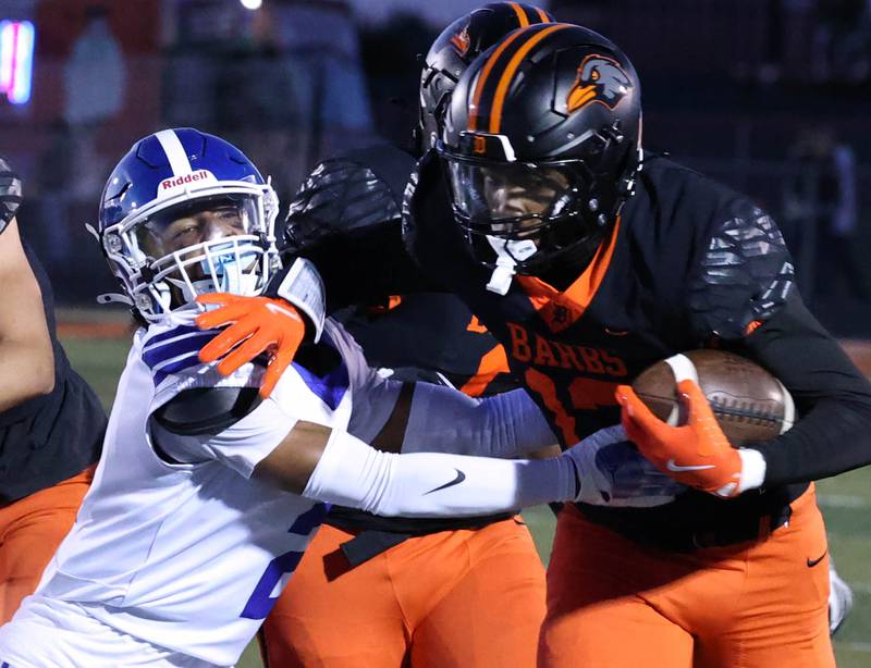 DeKalb's Davon Grant trys to shake free from Phillips' Ezekiel Williams Friday, Sept. 5, 2025, during their game at DeKalb High School.