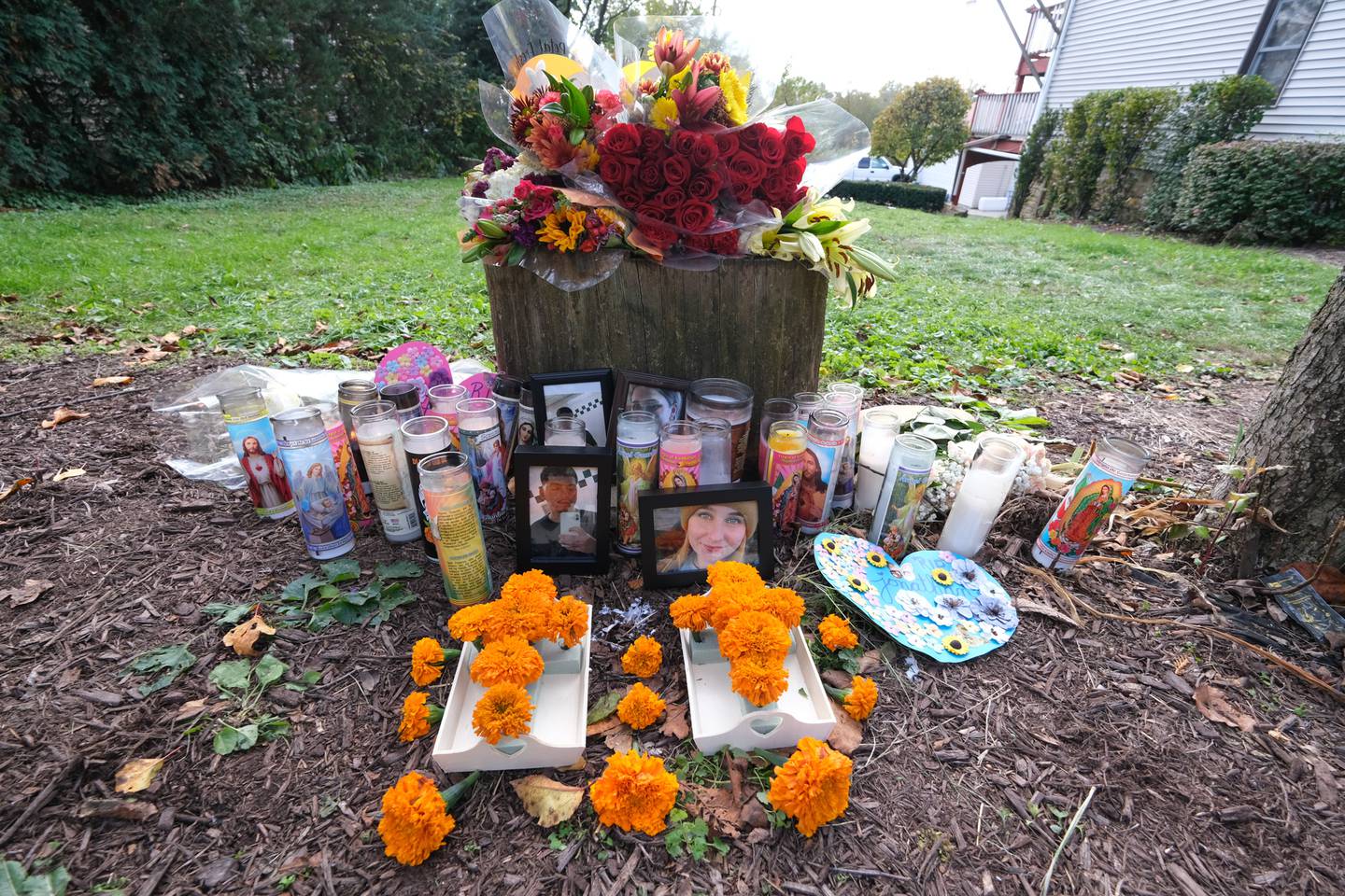 The memorial for Jonathan Ceballos and Holly Mathews, both 22, continues to grow outside the home of Oct. 31st mass shooting at a Halloween Party in Joliet on Wednesday, Nov. 3, 2021.
