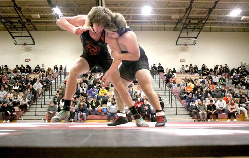 Huntley’s Jake Niemasz (right) battles McHenry’s Peyton Horowicz at 182 pounds in their Fox Valley Conference dual on Friday in Huntley.