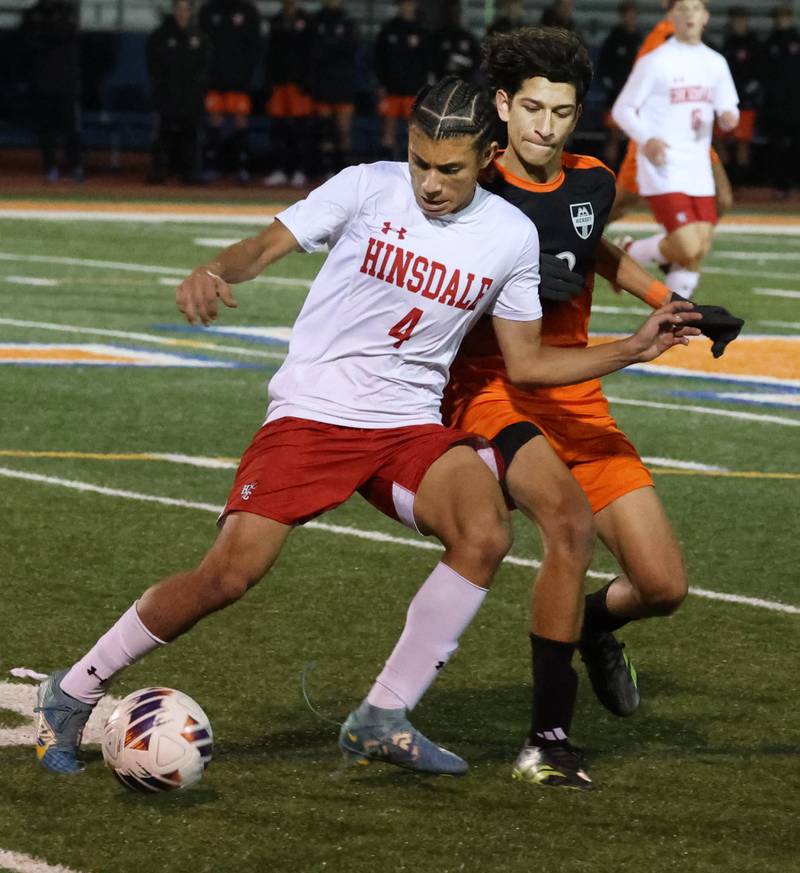 Hinsdale Central's Alex Barbu tries to hold off Hersey's Adam Myslinski Friday, Nov. 8, 2024, during their Class 3A state semifinal game at Hoffman Estates High School.