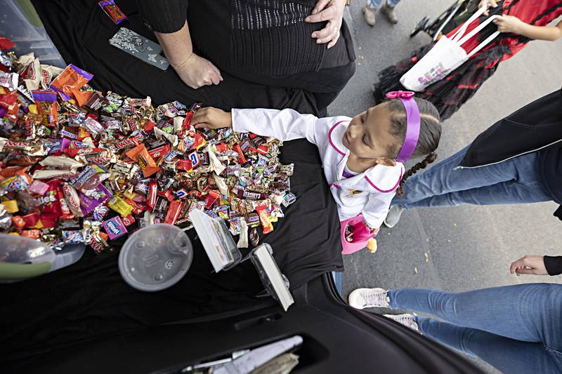 Kinley Townsend, 3, finds a sweet treat at the Sterling Main Street booth Wednesday, Oct. 25, 2023 while attending the Sterling Police Department’s trunk-or-treat.