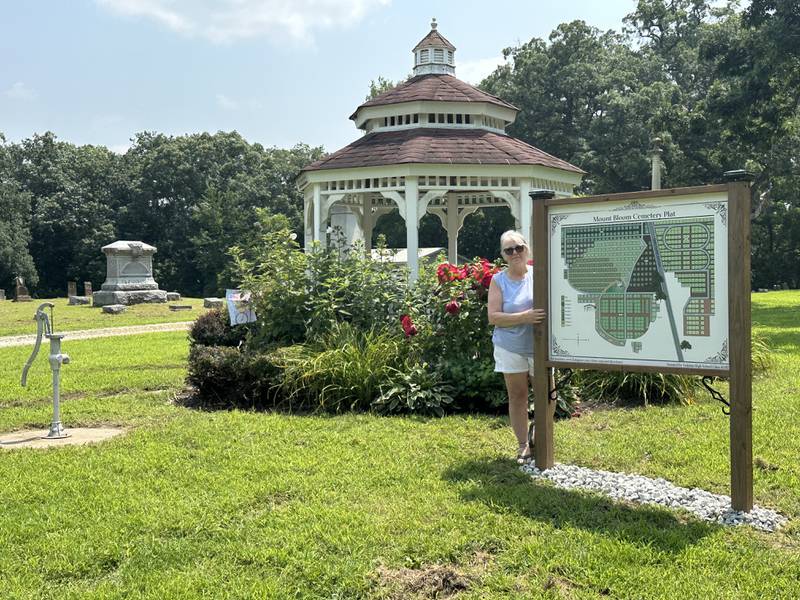 Pam Menery stands next to the gravesite map at Tiskilwa’s Mount Bloom Cemetery. Menery has put in the time and effort to log the graves in Mount Bloom and St. Mary Catholic Cemetery.