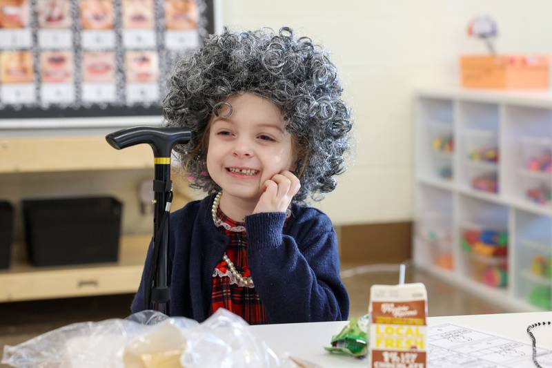 Shabbona Elementary School kindergartener Jaycie LaPalm scratches an itch from her wig while dressed up as a 100 year old during the 100th day of school on Monday, Feb. 9, 2026.