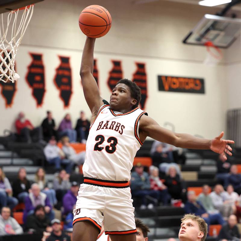 DeKalb’s Davon Grant soars in for the dunk during their game against Dixon Tuesday, Dec. 12, 2023, at DeKalb High School.