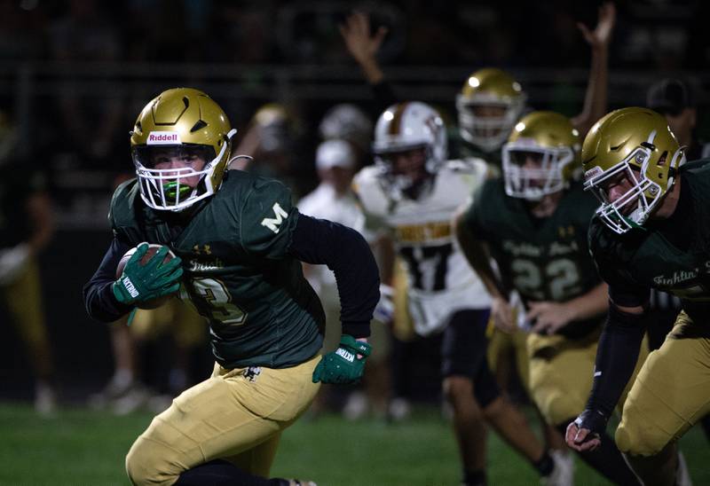 Bishop McNamara's Tucker Inman, left, carries the ball on a play in a game against Chicago Christian on Friday, September 19, 2025.