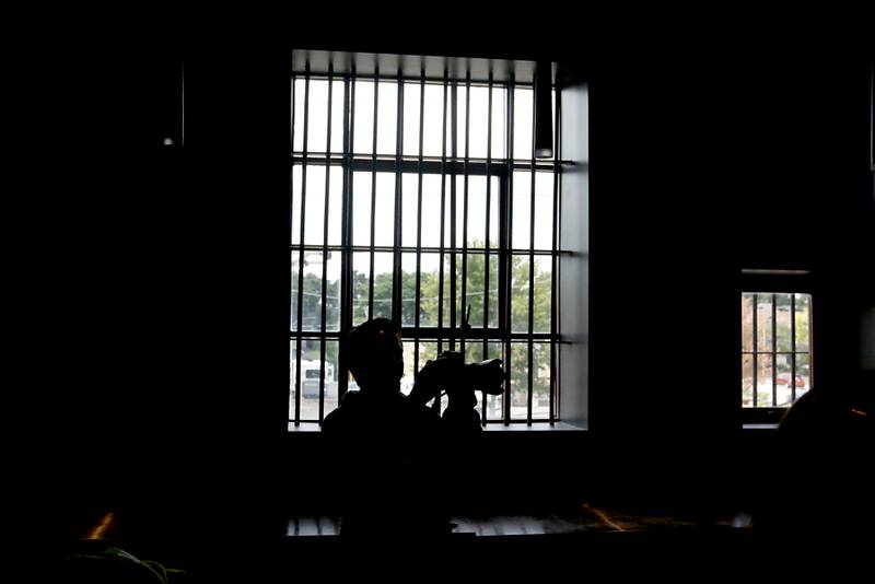 A photographer photographs the old jail cells being used in the newly remodeled Old Courthouse Center in Woodstock on Thursday, July 13, 2023, during a tour of the building.