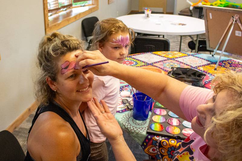 Lynda Mahalik, of Bourbonnais, has her face painted alongside Ava Deann Brueggert, 8, of Bradley, during the 5th annual Bourbonnais Food Truck Festival on Saturday, Aug. 16, 2025.
