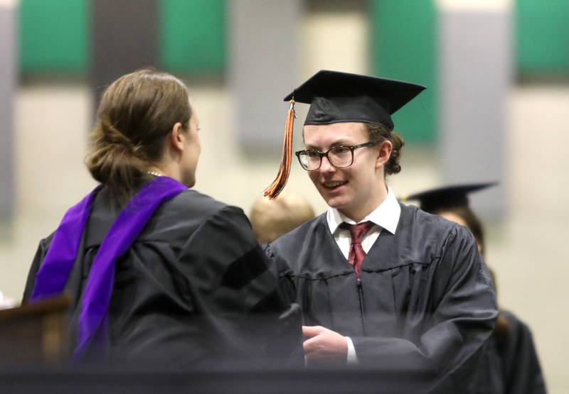Aidan Cutlan receives his diploma during the Wheaton Warrenville South commencement ceremony on Saturday, May 24, 2025 at the College of DuPage in Glen Ellyn.