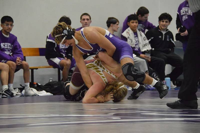 Rochelle's Alex Pelletier (purple) gets the upper hand in his match during a dual meet with Morris and Sandwich on January 8.