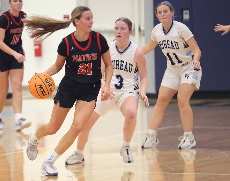 Erie-Prophetstown's Aubrey Huisman dribbles around Bureau Valley's Brooke Helms and Abby Jamison during the Thanksgiving Tournament on Wednesday, Nov. 19, 2025 at Bureau Valley High School.