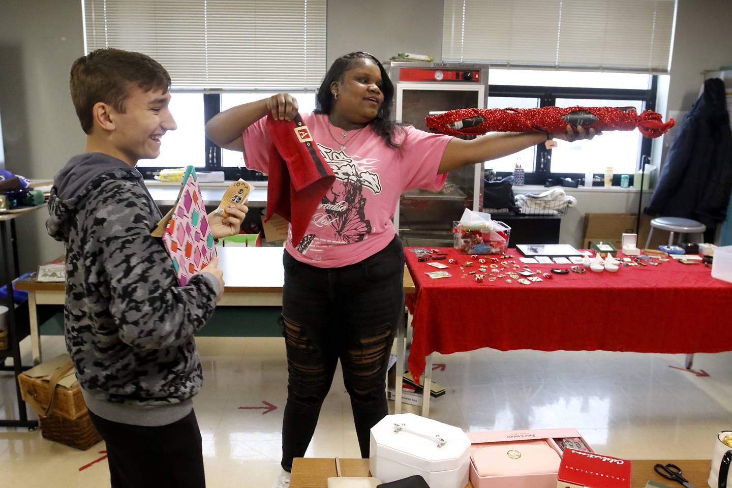 Johnny Marcantonio and Jakylah Jarrett try to decide what an item on Tuesday, Dec. 5, 2023, as they and other students in the job skills class at Haber Oaks Campus School, in Crystal Lake, set up  their Christmas store at the school. They run the store for fellow students to shop at using “Haber Bucks” money.