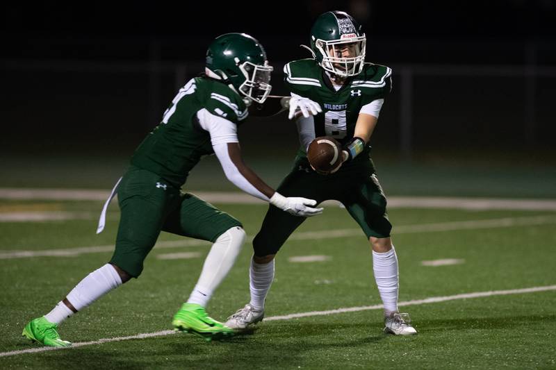 Plainfield Centrals Jeff Maliska hands off the ball to Javar Jones during a game against Joliet Central on Friday Oct. 11, 2024 at Plainfield Central High School