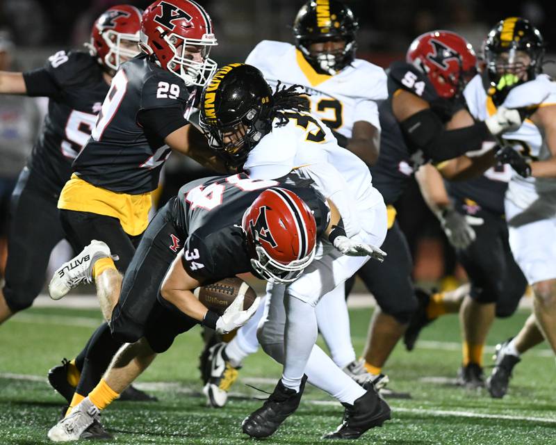 Yorkville's Gavin Geegan, left, gains some yards before being tackled by Joliet West's Jeremy Anderson (34) during the game on Friday Sept. 5, 2025, held at Yorkville High School.