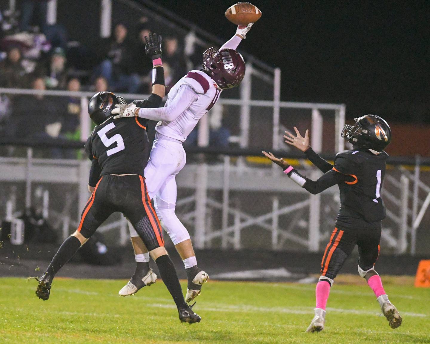 Sandwich's Simeion Harris, right, prepares to catch the ball as teammate  Cole Leeper (5) tries to defend the one-handed catch by Marengo's Parker Mandelky (4) thrown by his Quarterback and teammate David Lopez during the game on Friday Oct 25, 2024, held at Sandwich High School.