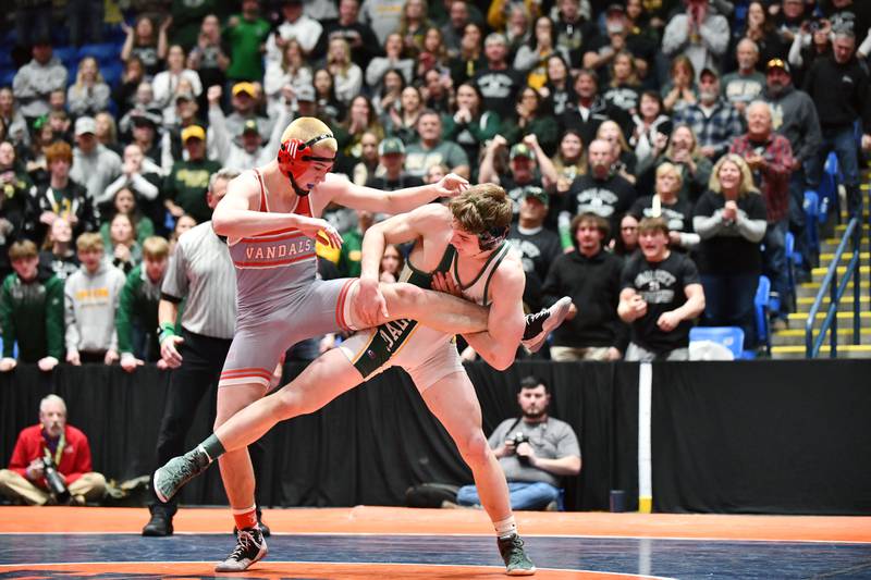 Aidan Kenney of Coal City grabs ahold of Cole Yarbrough of Vandalia during Kenney's 144-pound victory during the IHSA Dual Team State Finals in Bloomington on Saturday, March 1.