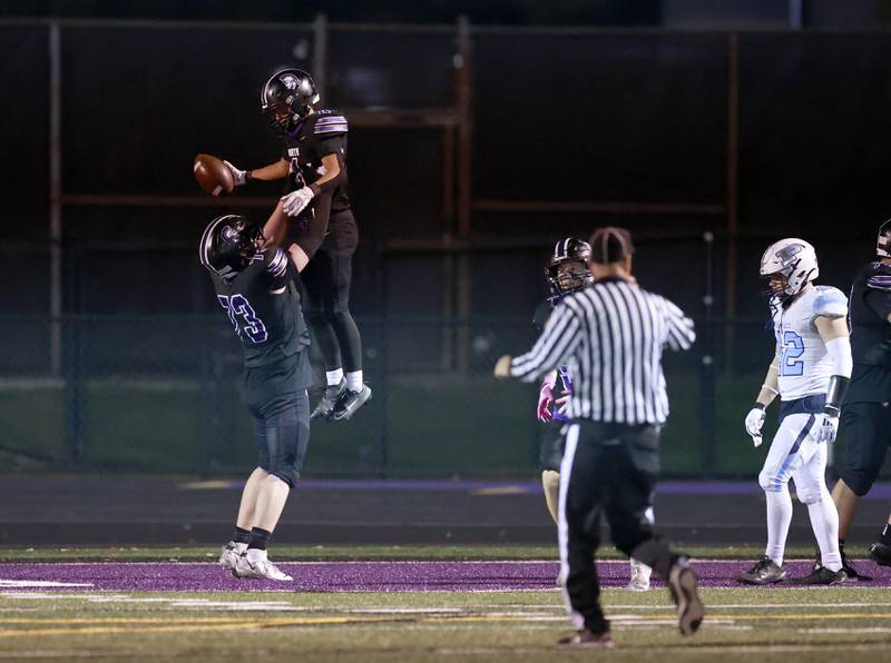 Downers Grove North's Colin Murphy (73) and Caden Chiarelli (4) celebrate a late touchdown during the IHSA Class 7A playoff football game Friday, Oct. 31, 2025 in Downers Grove.