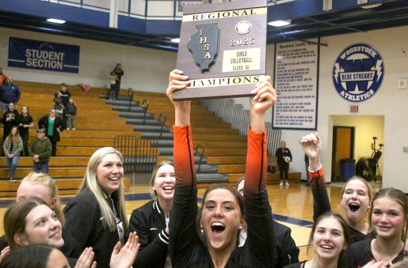 Crystal Lake Central’s Tigers hoist their hardware after a two-set win over Woodstock North in IHSA girls volleyball Class 3A Regional Championship action at Woodstock High School in Woodstock on Thursday, October 30, 2025.