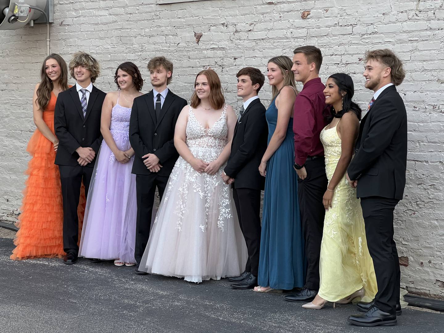 The 10 finalists of the 87th annual King and Queen Scholarship competition stand together before walking on the Genoa Days main stage on June 7, 2023. From left to right: Bailey Botterman, Aiden Awe, Molly Johnson, Nathan Brening, Corinne Lavelle, Trevor Finley, Kaitlin Rahn, Zachary Neblock, Citlani Serna and Nolan Perry.