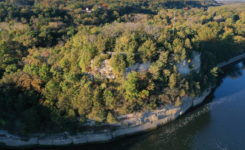 Trees begin to turn color on Thursday, Oct. 23, 2025 at the Starved Rock Lock and Dam. The fall colors have been late this season due to the dry drought conditions and warmer temperatures.
