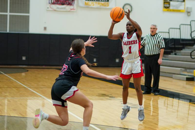 Bolingbrook's Airyel Jackson (1) shoots a 3-pointer against Yorkville's Sydney McCabe (22) during a Class 4A Metea Valley Regional final basketball game at Metea Valley High School in Aurora on Friday, Feb. 21, 2025.