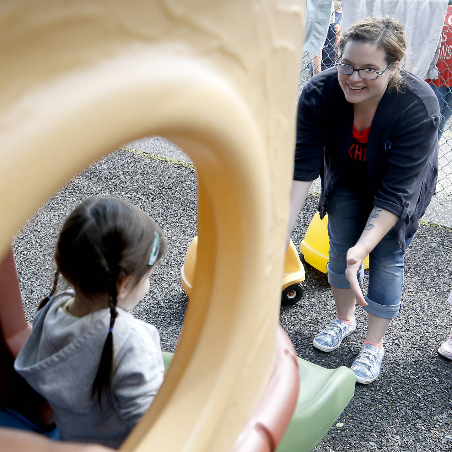 Teacher Ashleigh Bergstrand interacts with a with a student as she plays on the playground Thursday, July 28, 2022, at the Friendship House, 100 South Main Street, in Crystal Lake. Childcare centers are struggling to find enough teachers to maintain operations.