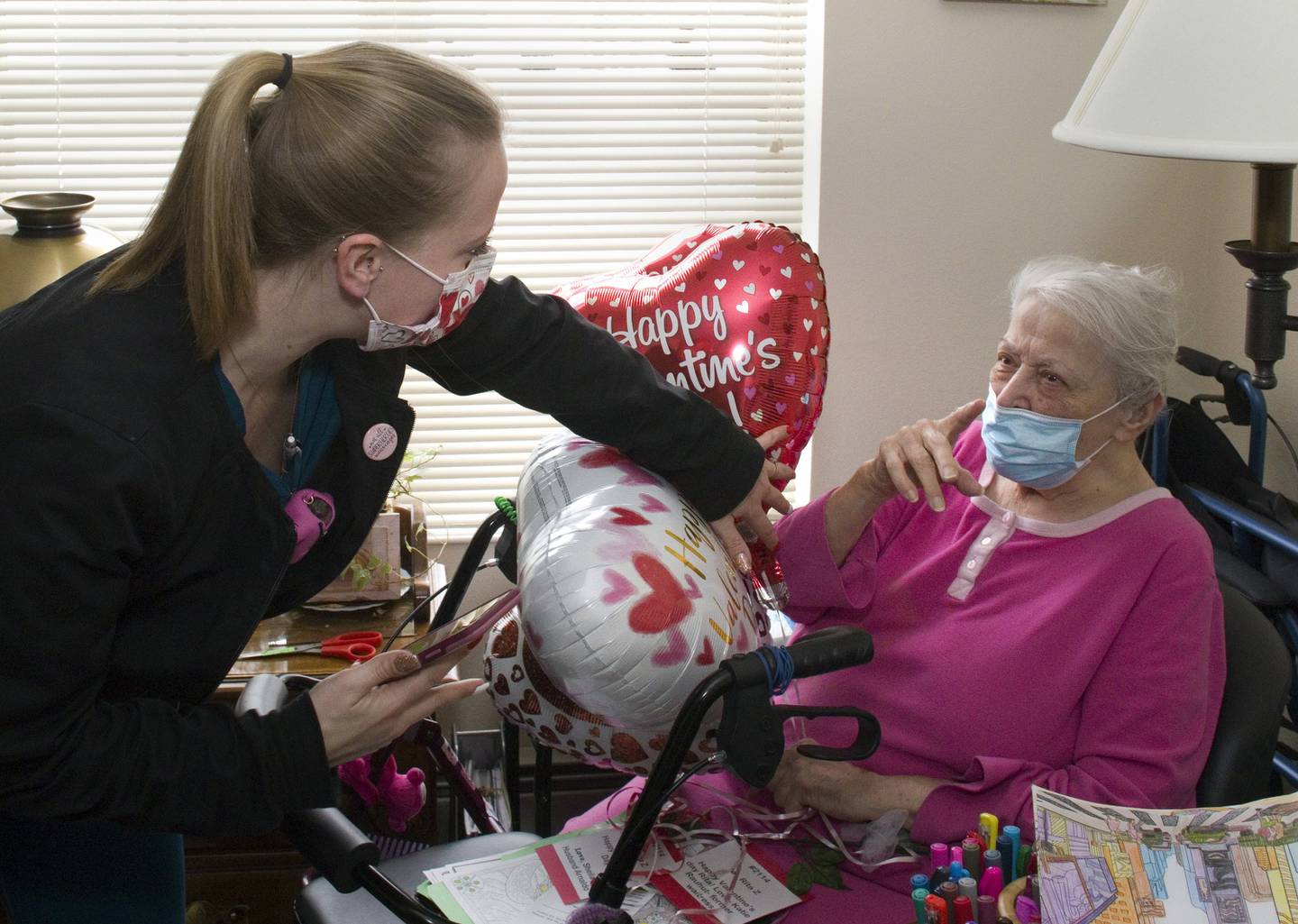 Kara Rauhut Timbers CNA passes out a special Valentine’s Day surprise to resident Rita Zobran. Families of residents, Timbers’ neighbors and local businesses purchased packages for residents. The package included a chocolate rose, a heart-shaped balloon, and a personalized card. The $1600 raised from the event was donated to the Alzheimer’s Association.