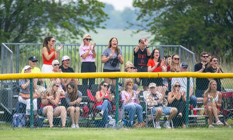 Benet Academy fans celebrate a hit by their team during a game against St. Francis High School during the Class 3A Kaneland Sectional final at Kaneland High School in Maple Park on Saturday, June 7, 2025.